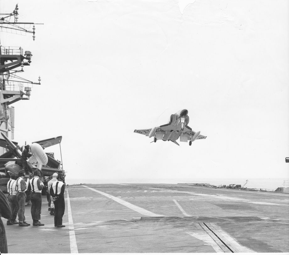 In the Western Approaches Phantom jets due to serve on HMS Ark Royal practice deck landing approaches on HMS Hermes.